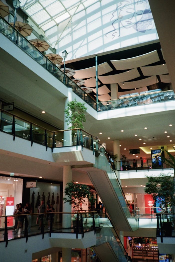Explore the contemporary architecture of a bustling shopping mall with vibrant displays in Porto, Portugal.