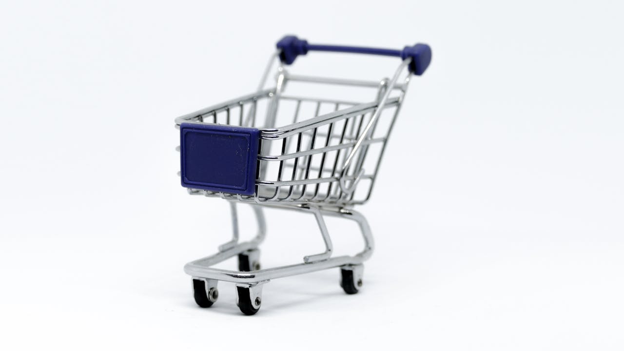 services-01 A modern miniature shopping cart on a clean white background, perfect for e-commerce concepts.